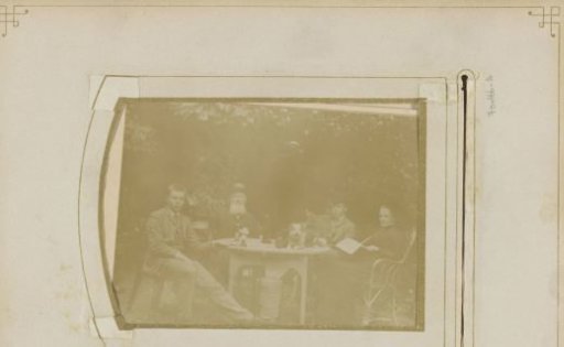 Portrait of a family at a garden table with a dog