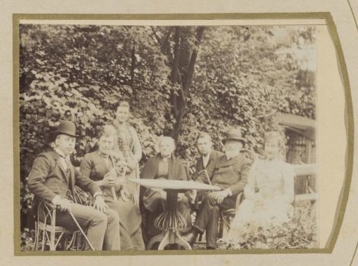 Portrait of a family at a garden table with a dog