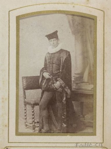 Portrait of a young man in costume beside a chair and a table with books, inscribed as J.W. Huijsinga