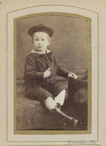 Portrait of a seated boy with a beret