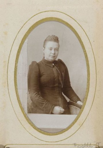 Portrait of a woman, seen through a doorpost
