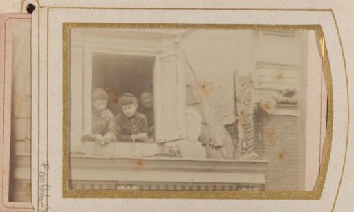 Two women in the window frame of a skylight