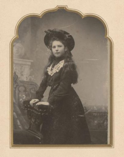 Portrait of a standing girl with a hat