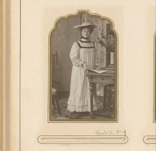 Portrait of a standing woman in a reform dress with a hat