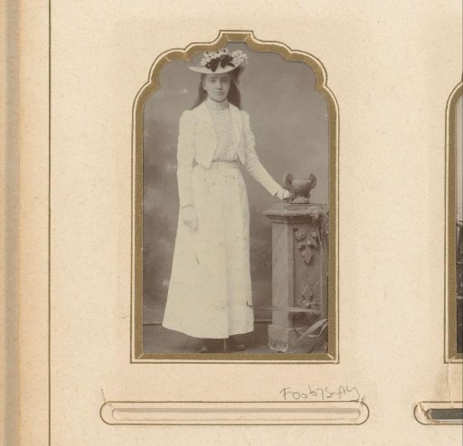 Portrait of a standing girl in a white costume with a hat