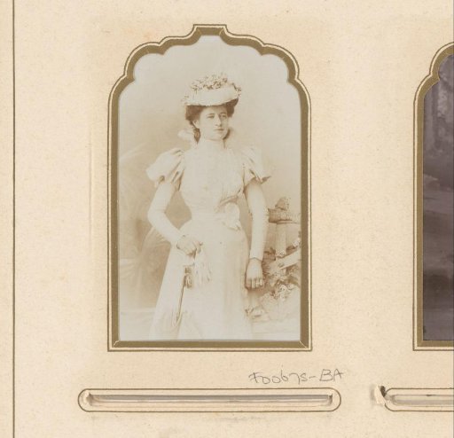 Portrait of a standing woman with gloves, umbrella and hat