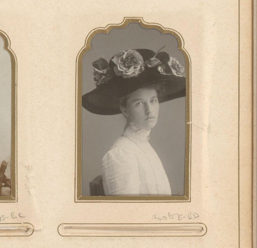 Portrait of a woman with a large hat adorned with flowers
