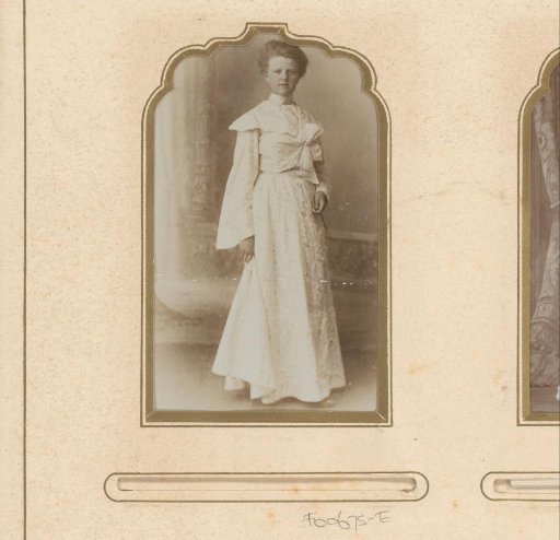 Portrait of a standing woman in a white dress