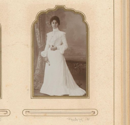 Portrait of a standing woman in a white dress