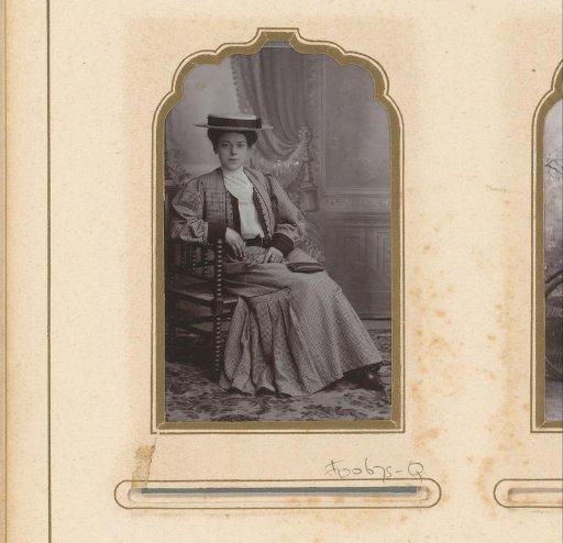 Portrait of a seated woman with a hat
