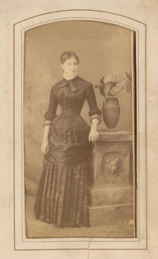 Portrait of a standing woman in a black gown
