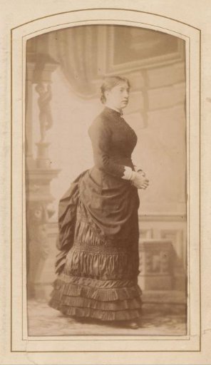 Portrait of a standing woman with a lifted skirt