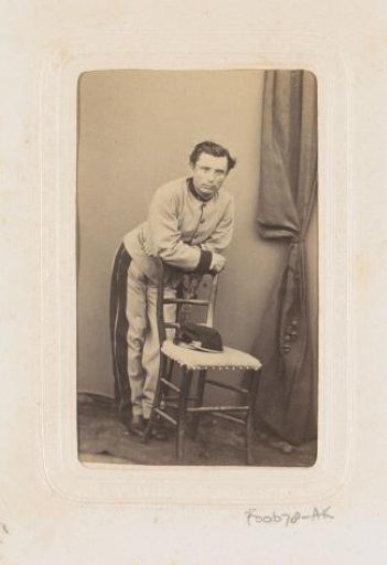 Portrait of a standing military officer leaning on a chair
