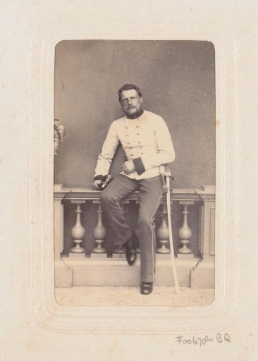 Portrait of a man in uniform seated on a balustrade