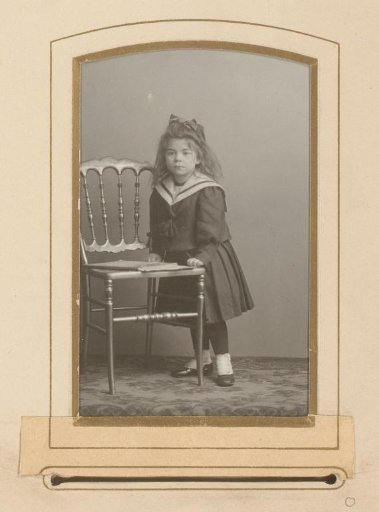 Portrait of a girl leaning on a chair