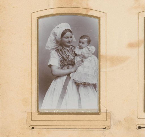 Portrait of a woman in traditional dress holding a baby