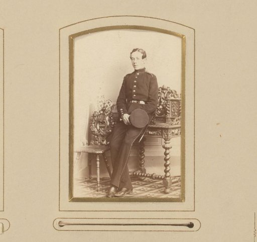 Portrait of a Young Man in Uniform with a Cap in His Hand, Leaning on a Writing Desk