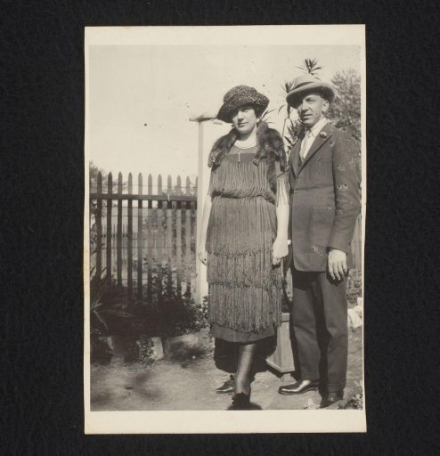 Portrait of a man and a woman in a garden, both wearing hats