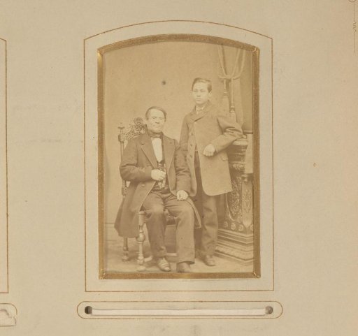 Portrait of a seated man and a standing boy