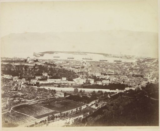 Town with harbour on the coast, possibly in Italy