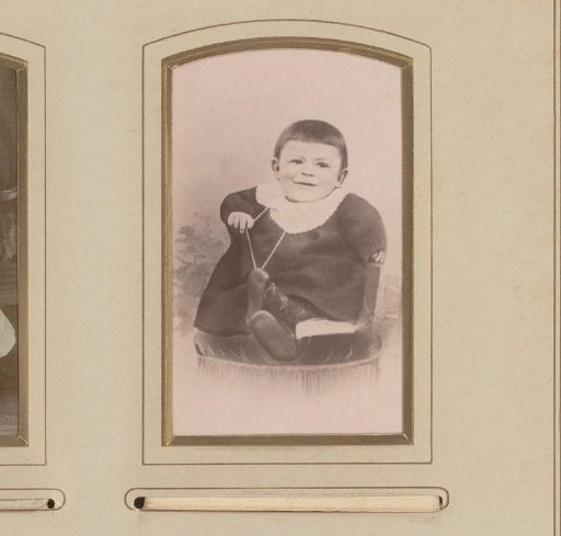 Photographic reproduction of a drawn portrait of a seated child