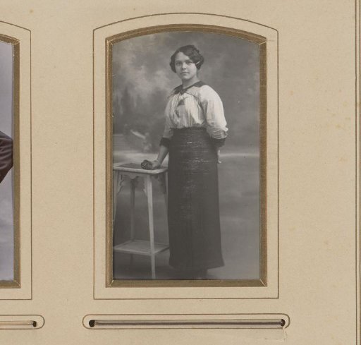Portrait of a Young Woman Standing by a High Table