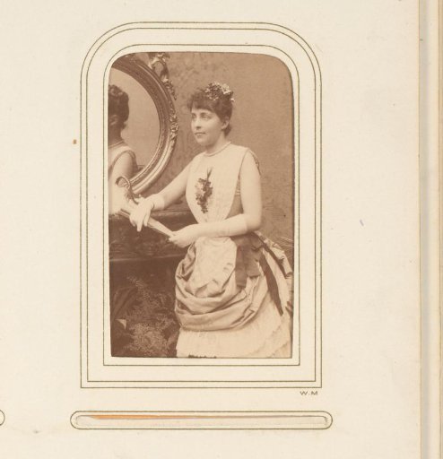 Portrait of Ellen Hartman beside a mirror