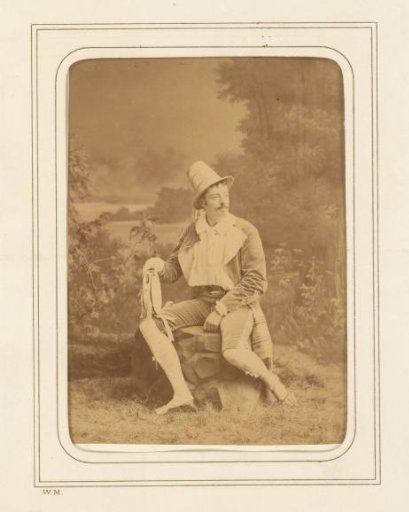 Portrait of an actor, seated in a landscape setting, identified as Michael Aagaard