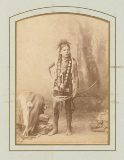 Portrait of a boy with arrow and bow in hand