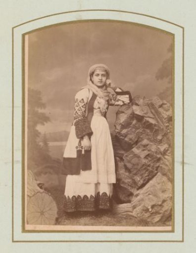Portrait of a young woman leaning on a rock