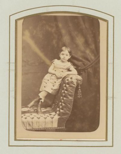 Portrait of a girl standing on a sofa