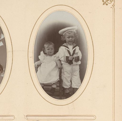 Portrait of two children, one seated on a chair