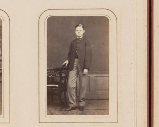 Portrait of a Boy Standing Beside a Chair