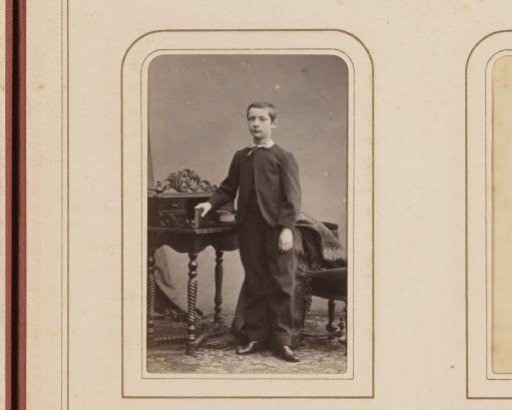 Portrait of a Boy Standing Beside a Writing Desk