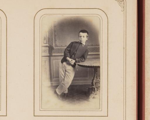 Portrait of a Boy Leaning on a Table