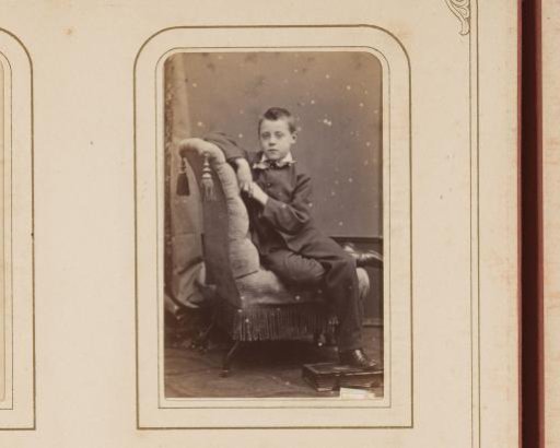 Portrait of a Boy on a Chair, with an Album under His Foot