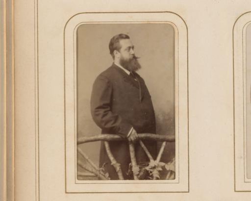 Portrait of a Man with Moustache and Beard Behind a Fence of Twigs