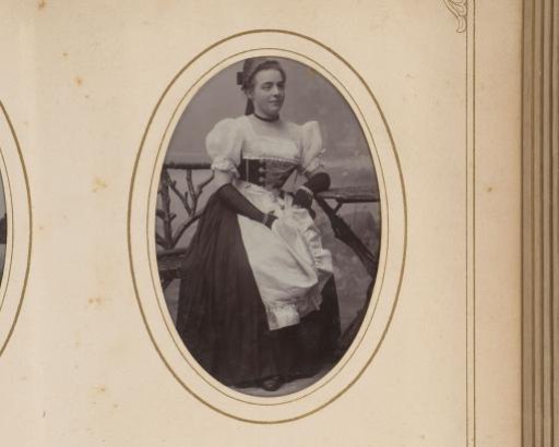 Portrait of a woman seated at a table
