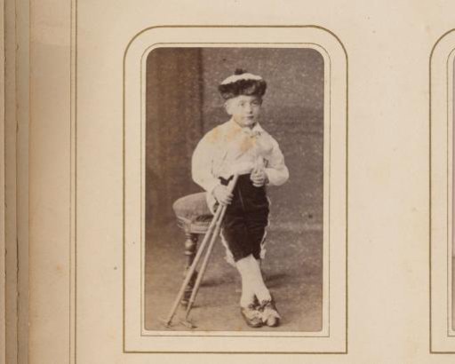 Portrait of a boy leaning on a crutch