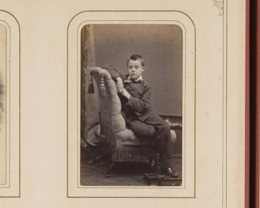 Portrait of a Boy on a Chair, with an Album Under His Foot