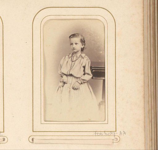 Portrait of a standing girl by a table