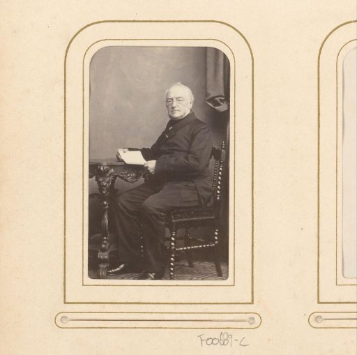 Portrait of a seated man with a book