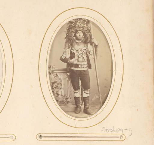 Portrait of a standing man in historical costume with plumed hat and halberd