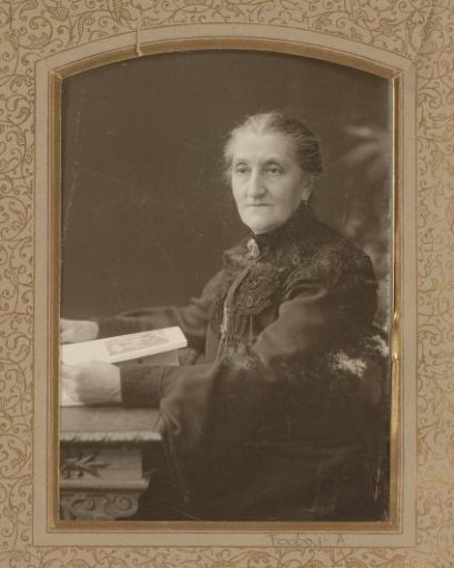 Portrait of a woman at a desk with a book