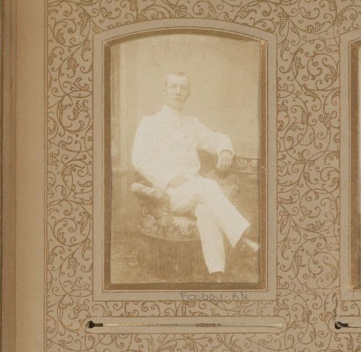 Portrait of a seated man in white uniform