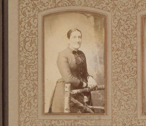Portrait of a woman by a fence