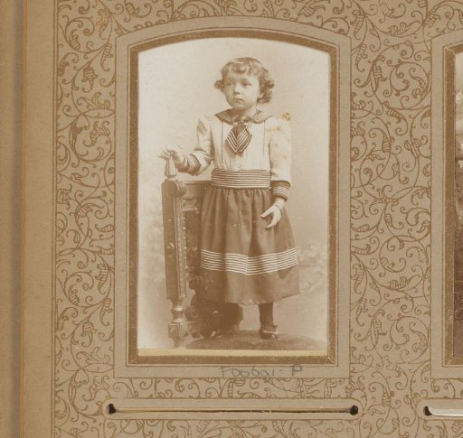 Portrait of a child standing on a chair