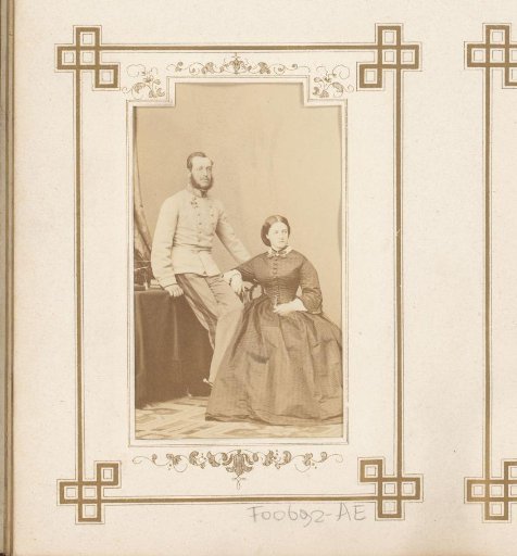 Portrait of a seated woman and a man with sideburns