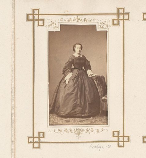 Portrait of a woman by a chair
