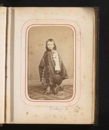 Portrait of a boy in Romanian traditional dress with a hat and cape